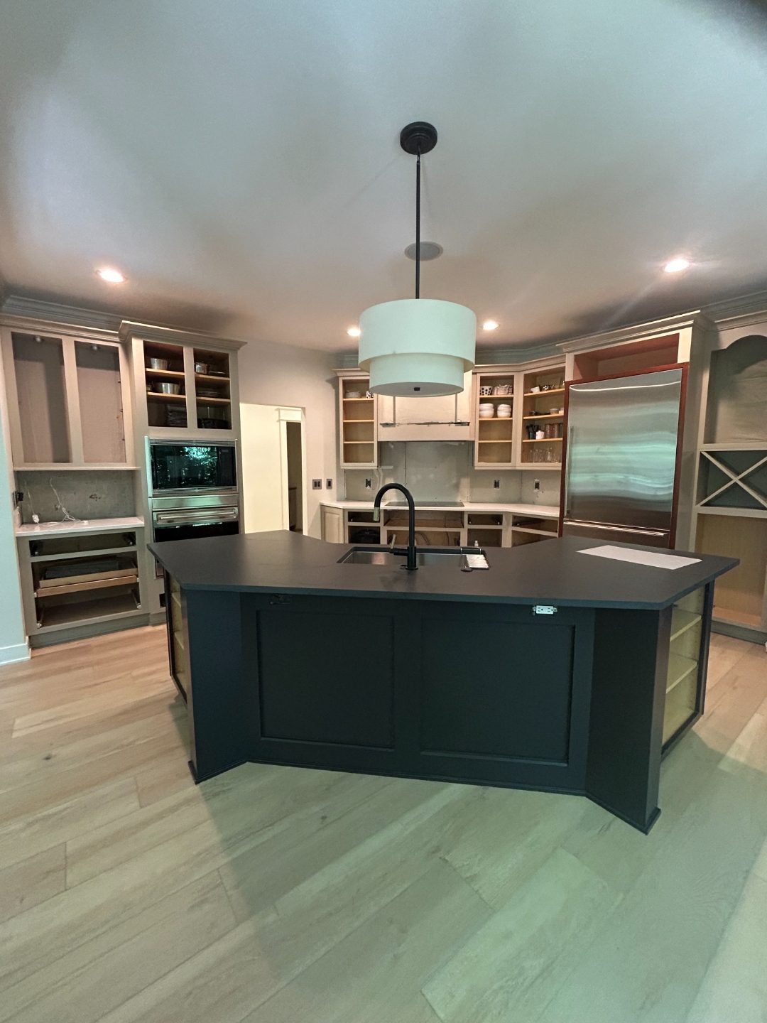 Modern kitchen with custom-painted deep navy island finished by GRC Painting